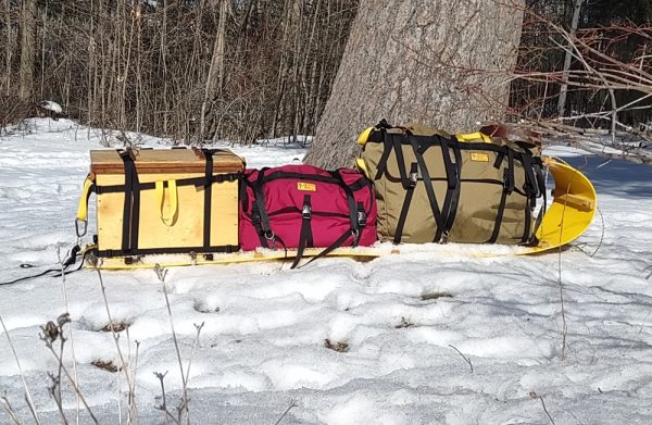 Voyageur, Coureur and Wanigan on a winter sled.